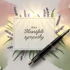 A sympathy card surrounded by watercolor flowers, lavender sprigs, and a fountain pen