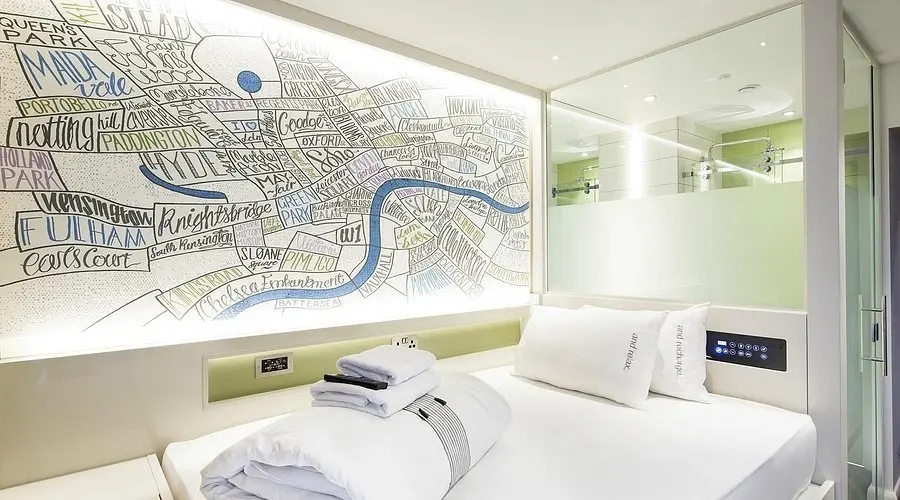 Compact hotel room at Hub by Premier Inn Covent Garden with a bed and large London map artwork