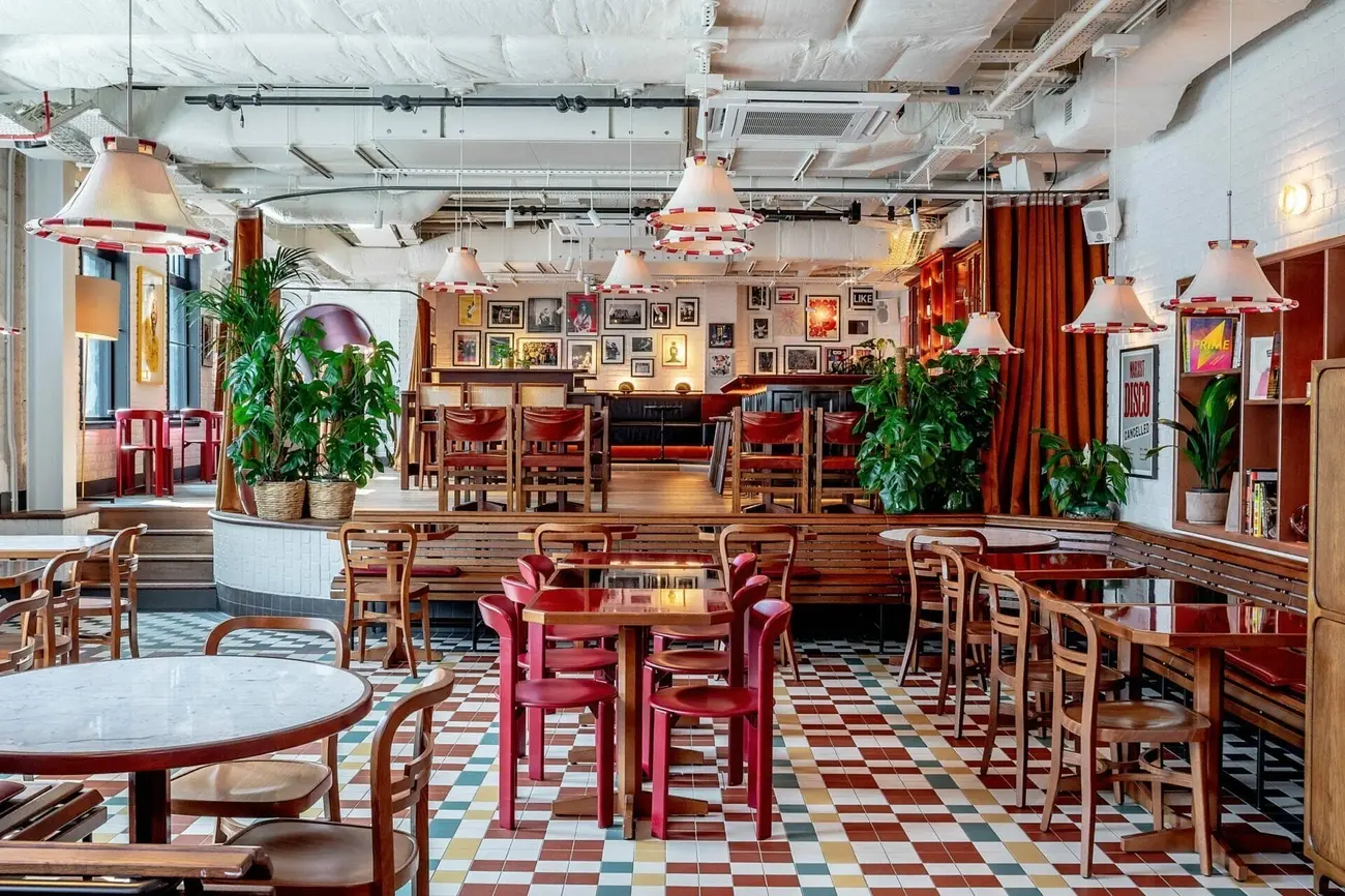 Table laden with pizzas, cocktails, and brunch dishes at Cafe KOKO in Camden