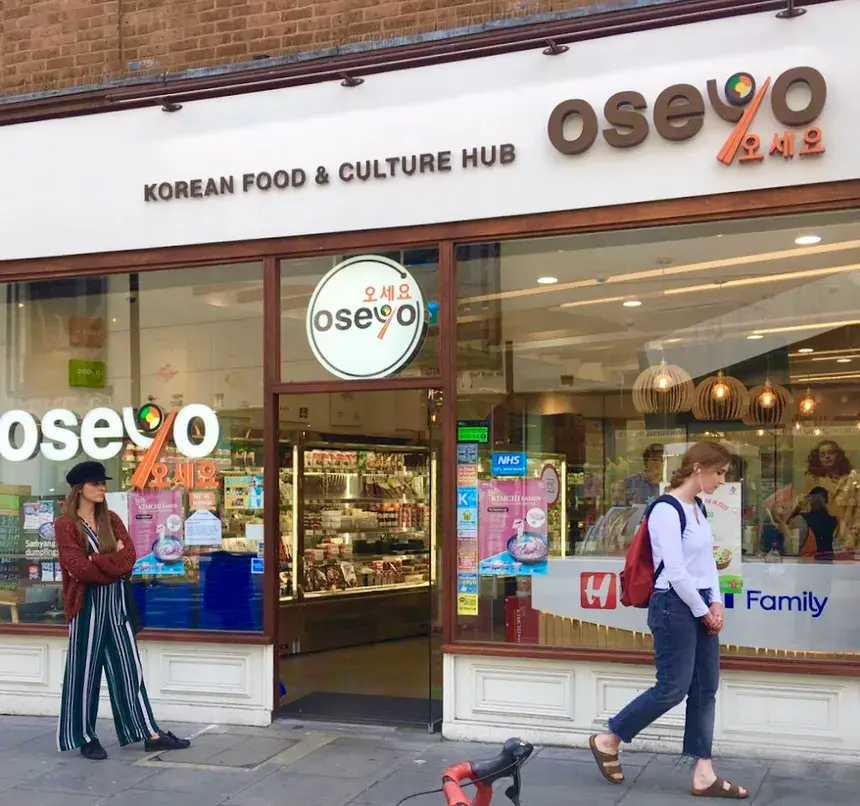 The storefront of an Oseyo, a Korean Food & Culture Hub in London, with people walking past