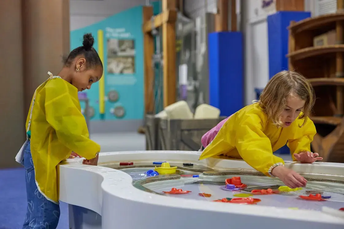 Kids at Mudlarks water table, Museum of London Docklands; interactive Thing to Do in London with Kids