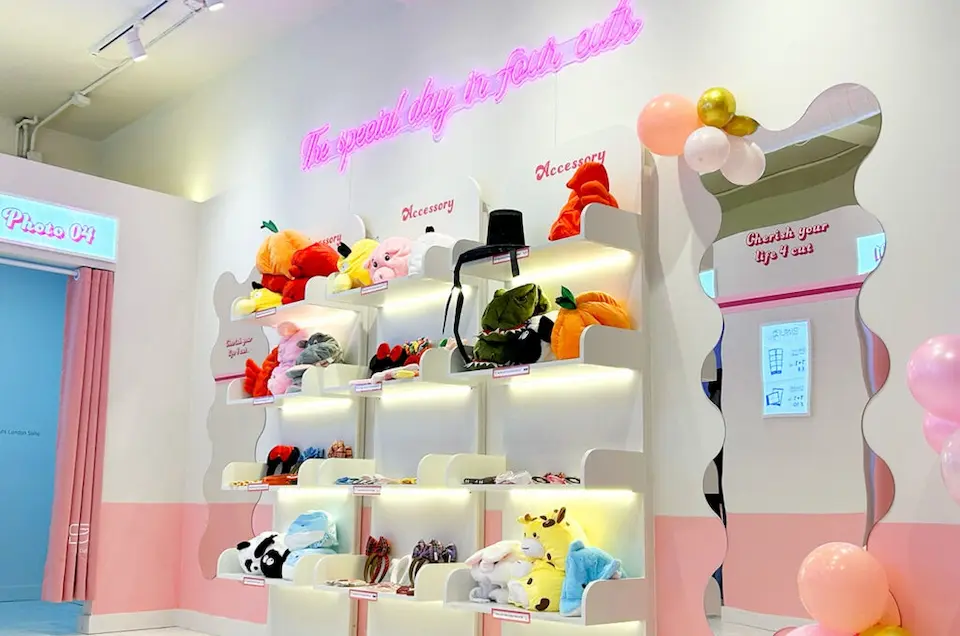Accessory wall at K-Pop Playground with novelty headbands next to the entrance of a Korean-style photobooth