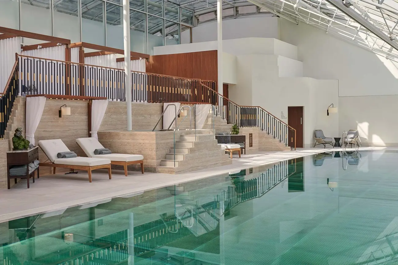 Brightly lit indoor swimming pool at The Peak Fitness Club & Spa, Jumeirah Carlton Tower