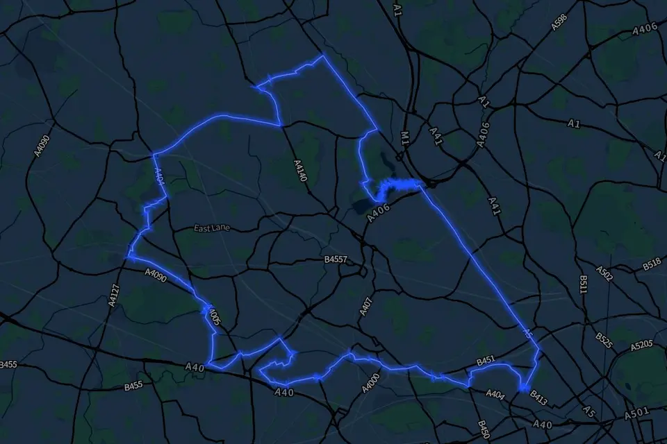 A nighttime map of North West London with the boundary of the borough of Brent highlighted in a glowing blue line