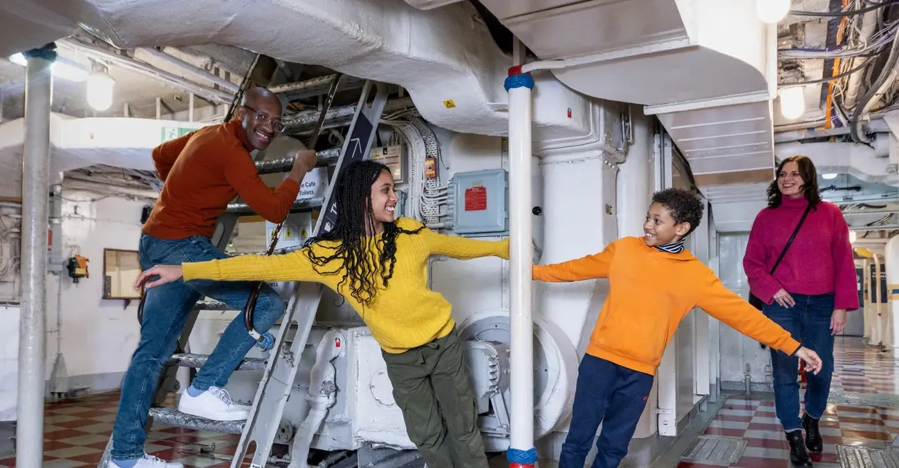 Family explores HMS Belfast interior; an engaging Thing to Do in London with Kids