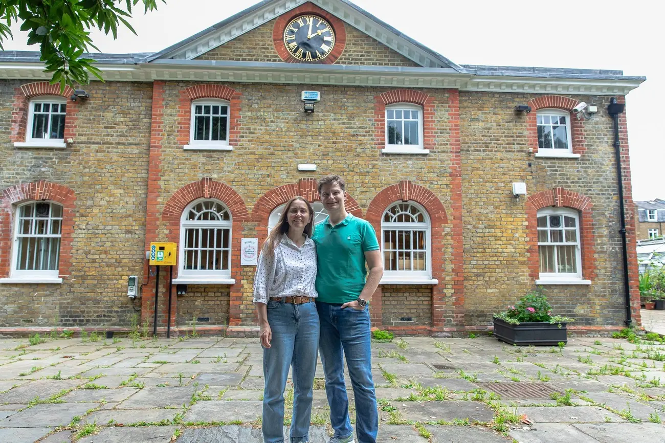 Couple standing outside the Ravenscourt Park Tea House, a cafe in one of Hammersmith's lovely Parks in London