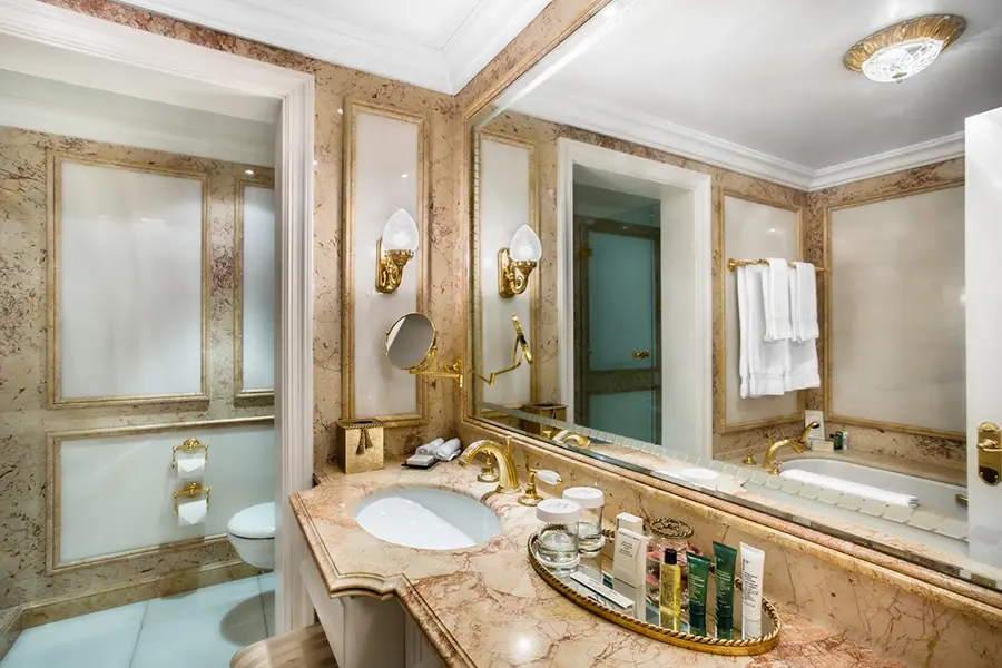 Luxurious marble bathroom at The Bentley London featuring a large whirlpool bath