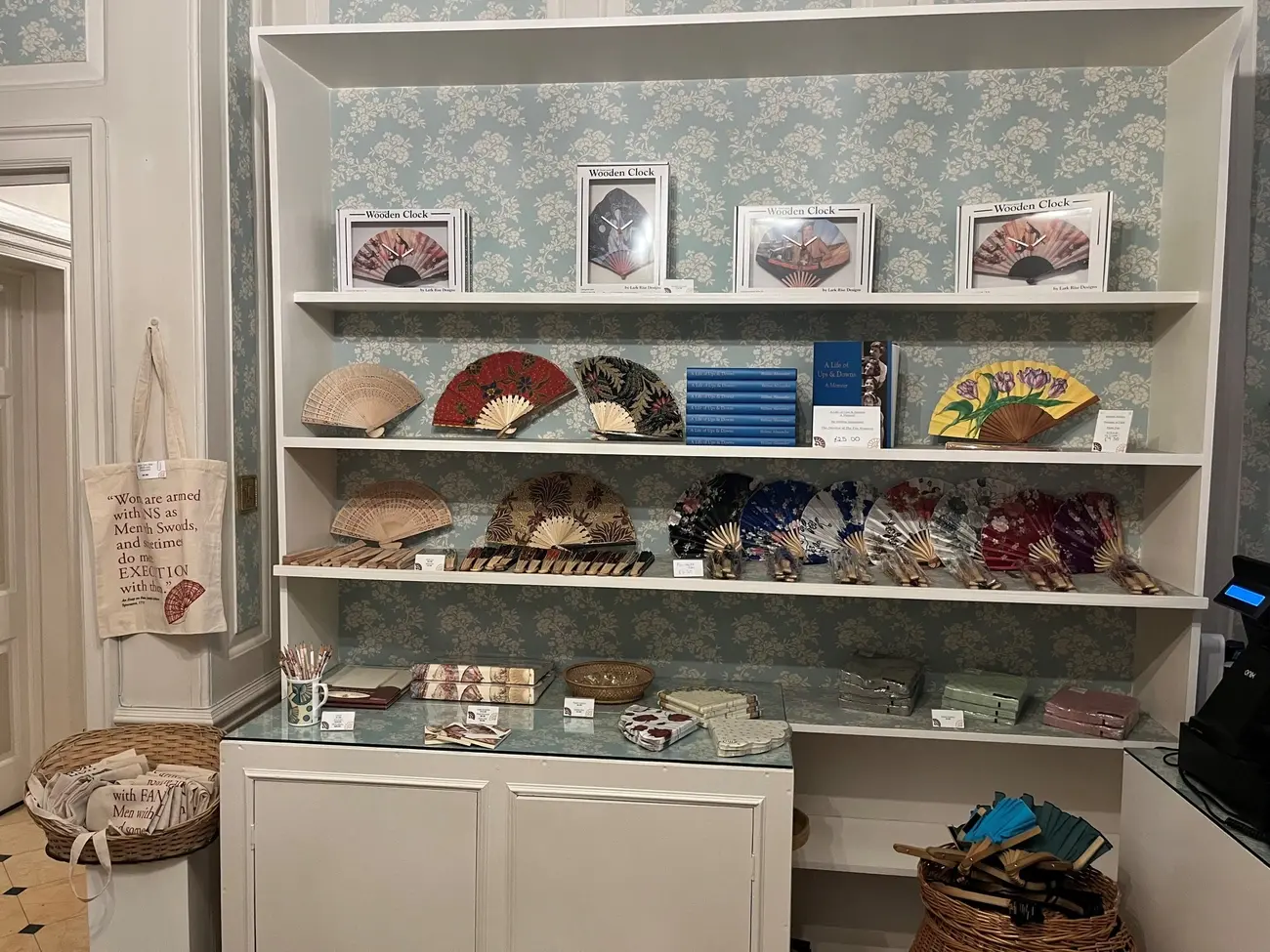 Display shelves in The Fan Museum gift shop in Greenwich, showcasing a variety of decorative handheld fans