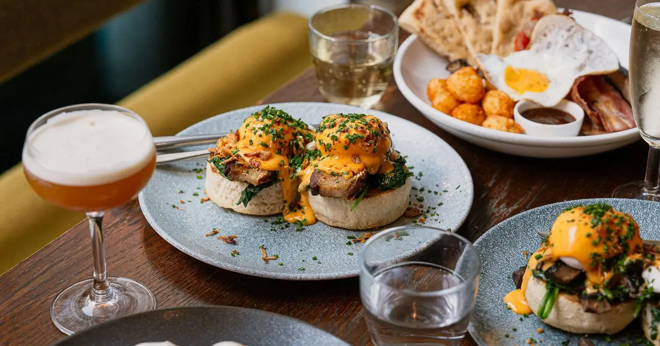 Delicious Australian-inspired brunch dishes, including eggs benedict, served at Lantana Cafe Shoreditch