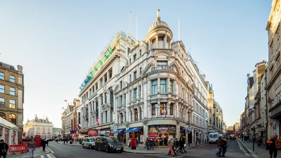 Grand Trocadero building, home to Zedwell Piccadilly Circus, on a London street with pedestrians