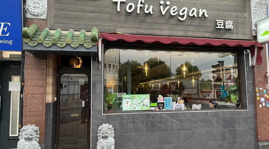The exterior of Tofu Vegan, a Chinese restaurant in London with a traditional green-tiled entrance