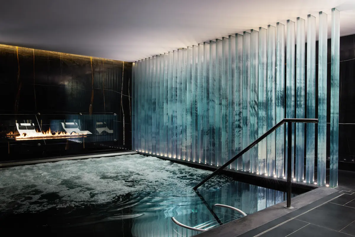 Luxurious silver-tiled vitality pool and jacuzzi area at ESPA Life spa, Corinthia London