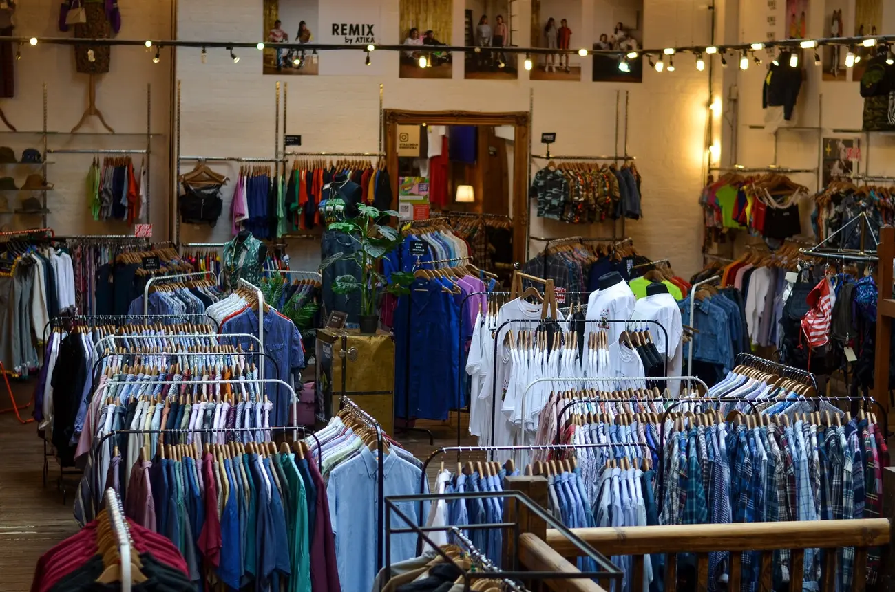 Spacious interior of ATIKA London, filled with vintage clothing racks in its Shoreditch location