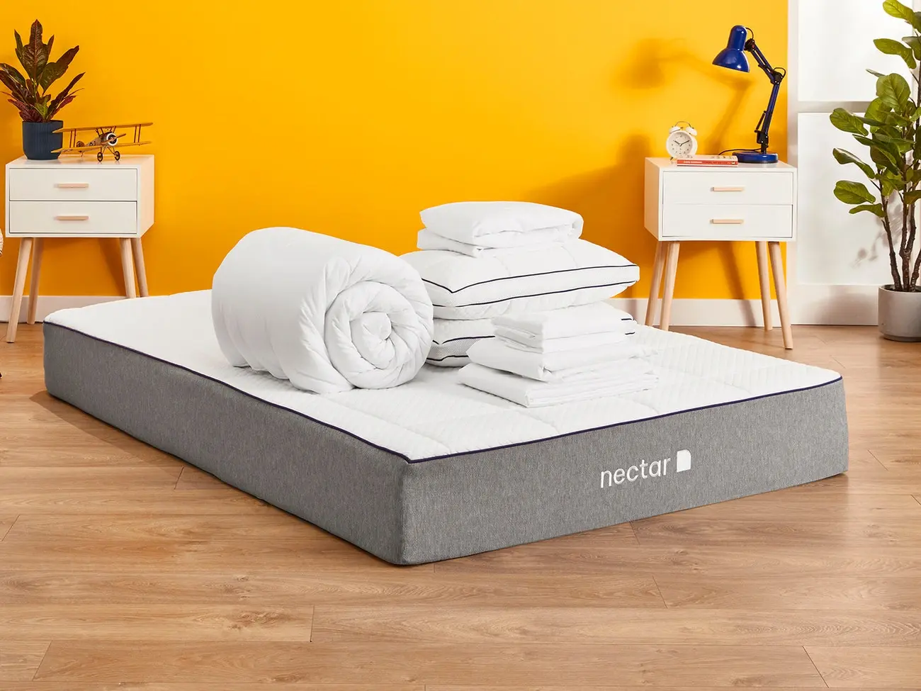 Nectar memory foam mattress on floor with pillows, duvet, and sheets bundle