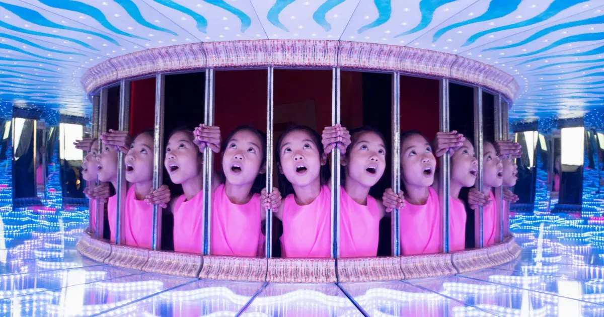 Young girl enjoys a fun Thing to Do in London with Kids inside a captivating mirror maze exhibit
