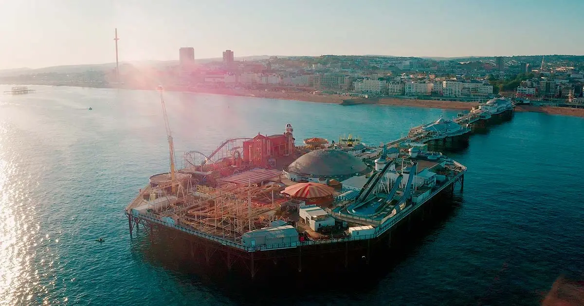 Aerial view of Brighton Palace Pier at sunset, showing rides and structure, a fun Thing to Do in Brighton