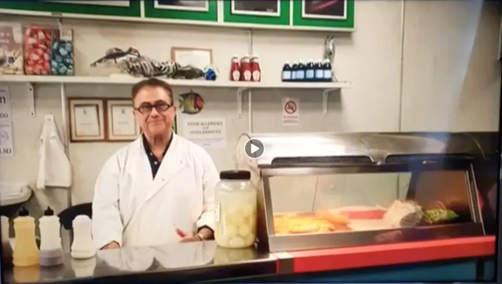 Interior of Knight's Fish Bar in Holloway with staff member serving