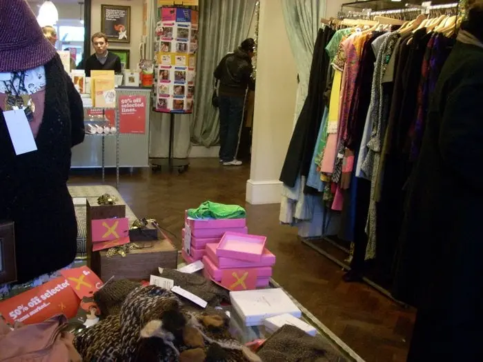 Exterior view of an Oxfam charity shop in Notting Hill, with clothing visible in the window display