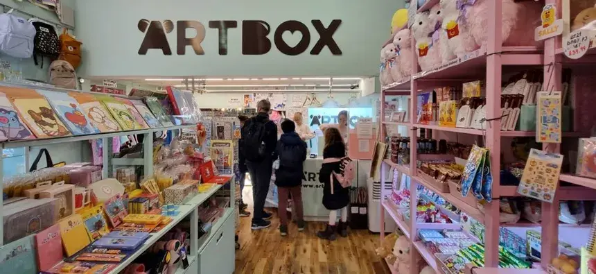 The colourful interior of the ARTBOX store in London, with shelves full of cute kawaii merchandise and shoppers at the counter