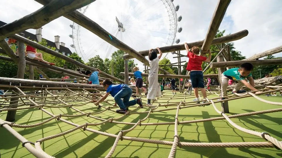 Children climb a large rope structure at Jubilee Gardens playground; a fun Thing to Do in London with Kids