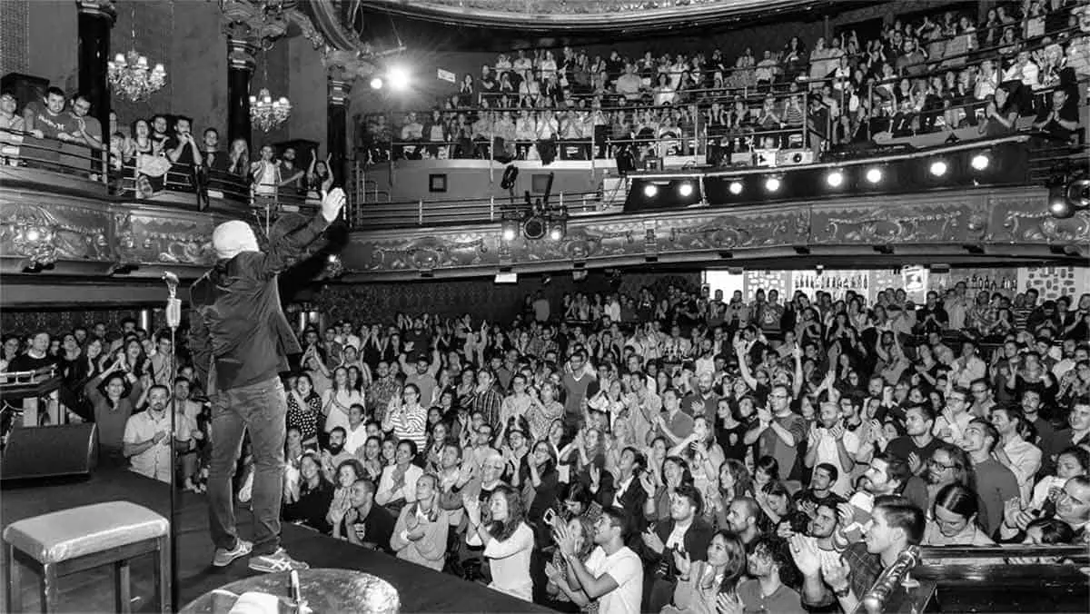 Comedian performing to a large audience at one of the Comedy Clubs in London
