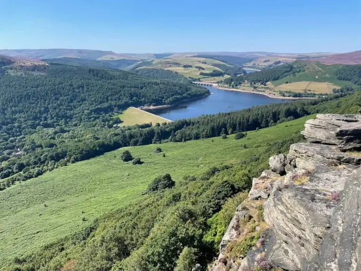 View from Bamford Edge overlooking Ladybower Reservoir and surrounding green hills
