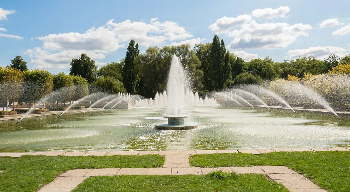 Large ornate fountain spraying water in the lake at Battersea Park, one of the beautiful Parks in London