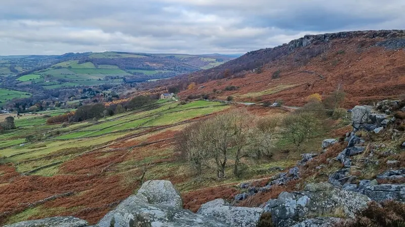 Autumnal view from Baslow Edge across bracken-covered slopes towards distant hills