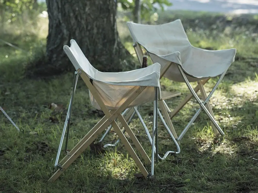 Two Snow Peak Take Bamboo chairs with canvas seats on grass under a tree