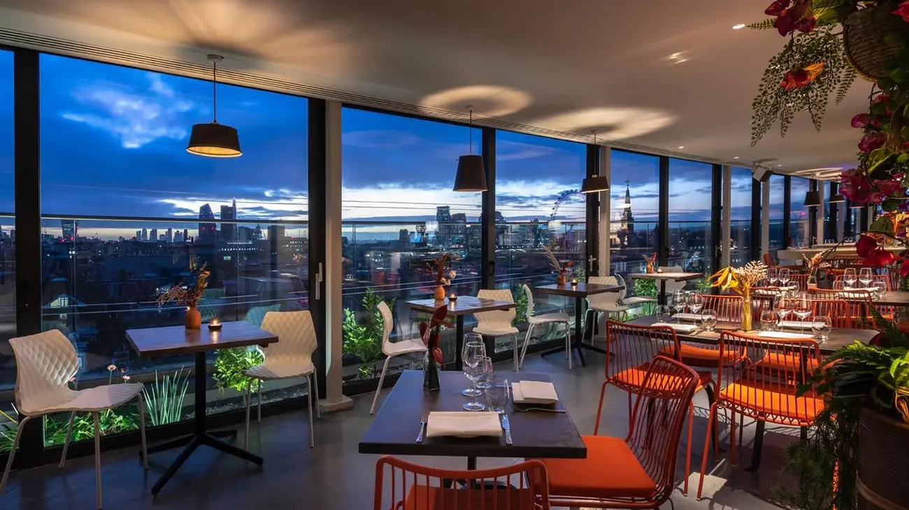 Chic rooftop bar at Assembly Hotel Leicester Square with panoramic London skyline views at dusk