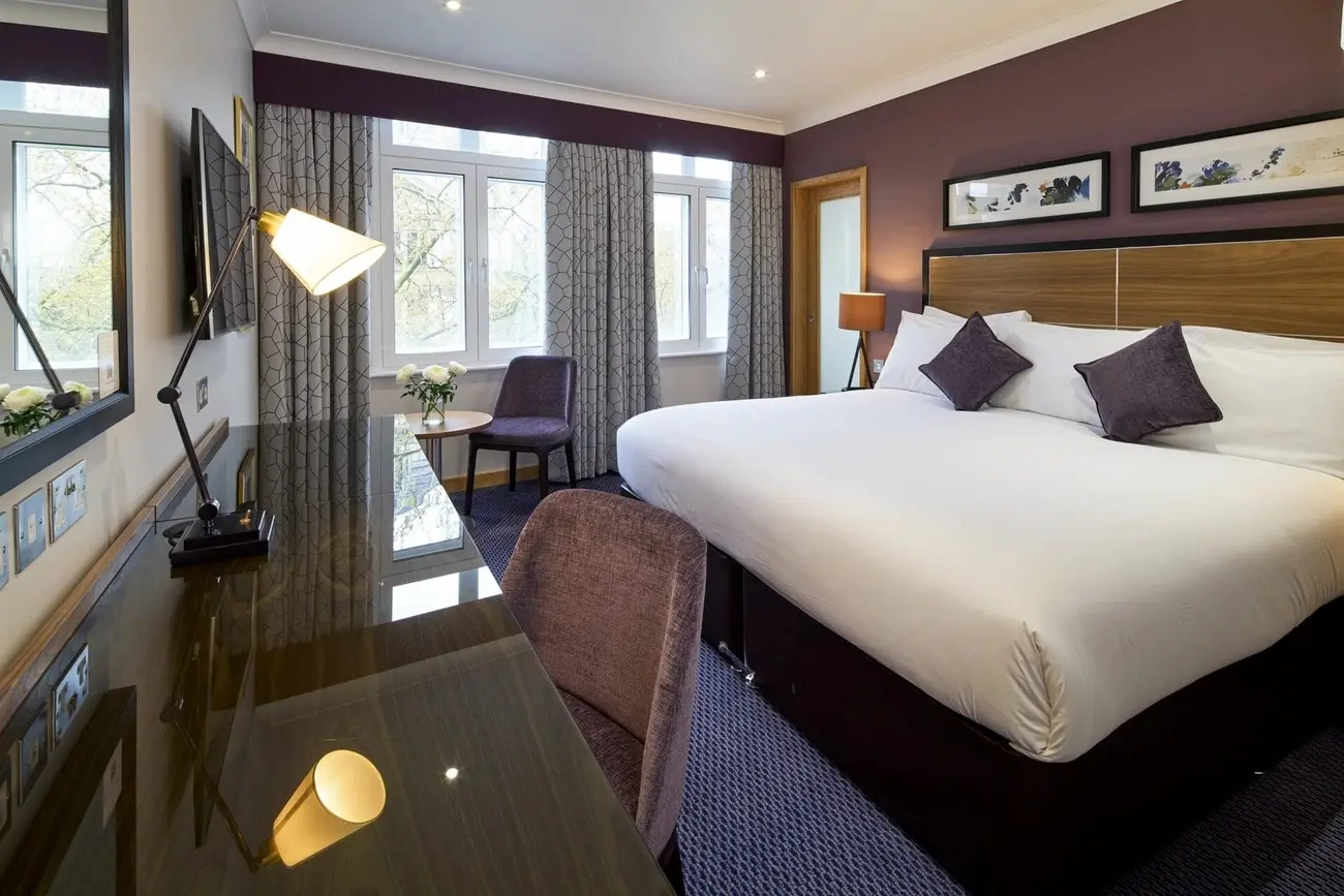 Bright executive hotel room at The Rembrandt featuring a glimpse of the jacuzzi bath